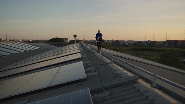 Engineer use drone for inspection installation solar cell panel on rooftop of factory