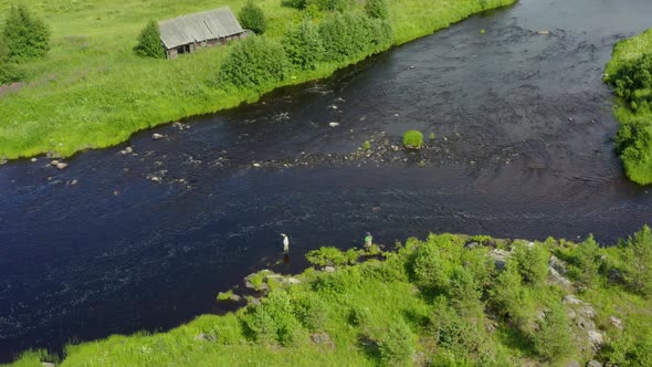 Aerial View of Two Spinning Fishermen Fishing on a Mountain River, Karelia
