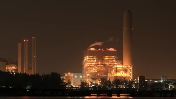 Time-lapse of electrical power plant near the sea coat at night, Rayong, Thailand alt