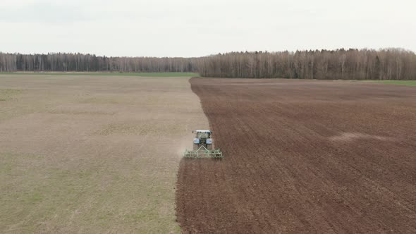 Tractor Plows The Farm Field alt