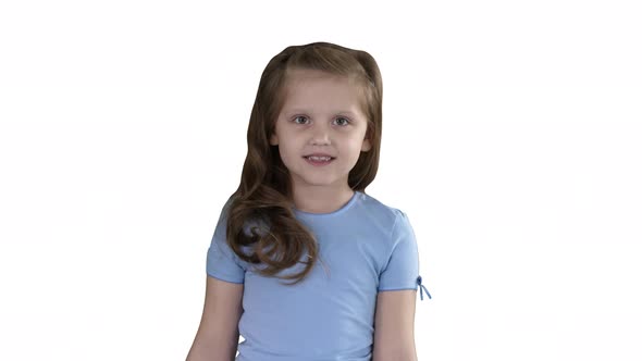 Beautiful Girl Laughs and Dances While Walking on White Background. alt