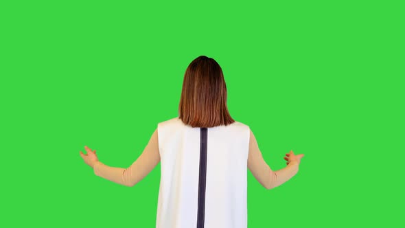 Cyber Girl Stands Spreading Her Arms Slowly on a Green Screen Chroma Key