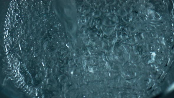 Bubbling Water Pouring Glass Top View alt