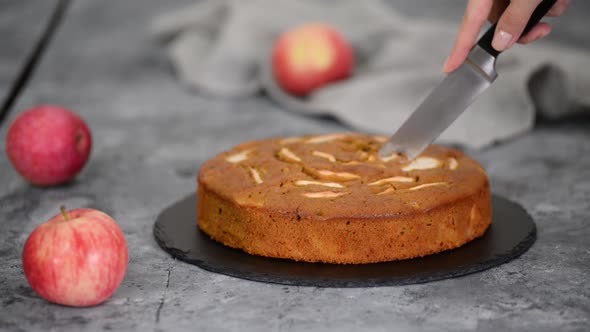 Cutting home baked caramel apple cake. Autumn pastries.