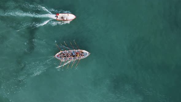 Aerial drone view of sport canoe operated by team in mediterranean clear waters.
