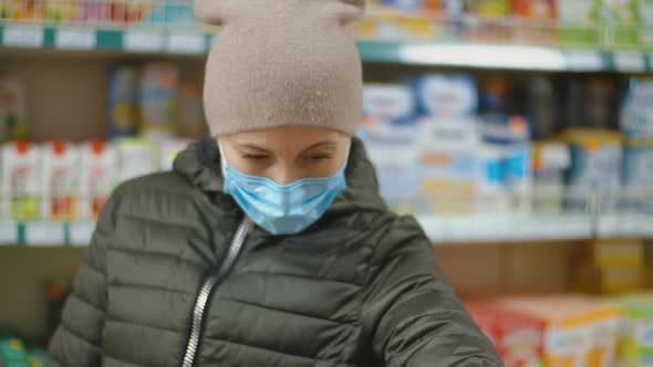 Woman in Medical Mask Shopping at the Supermarket alt