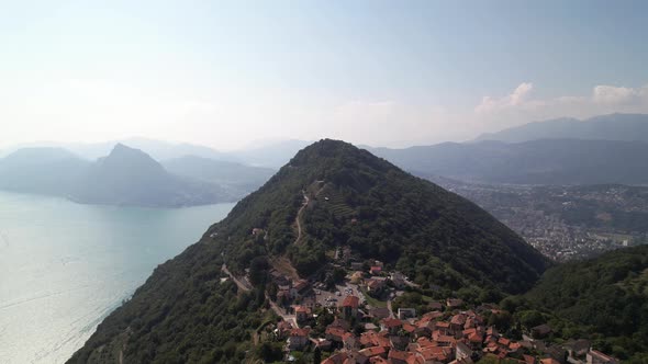 Epic cinematic flight over village and mountain brè in Lugano, Switzerland alt