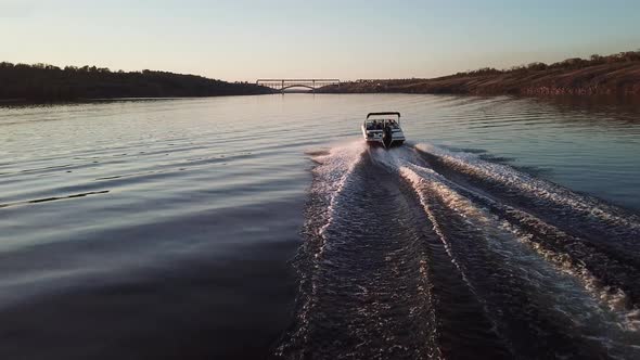  Motor Boat Floating on the River at Sunset