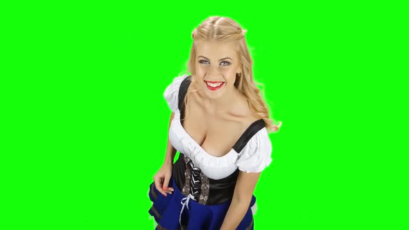 Girl in Bavarian Costume Shows Thumb and Waving. Green Screen alt