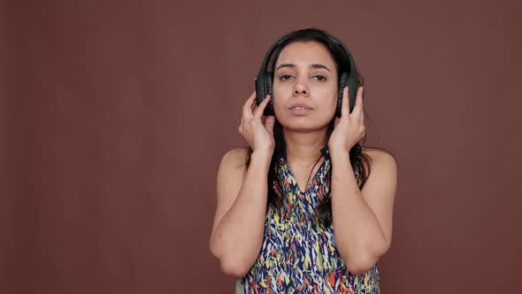 Indian Woman Having Fun Listening to Music on Headphones alt