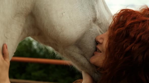 A Woman Is Engaged in Hippotherapy Outdoors.