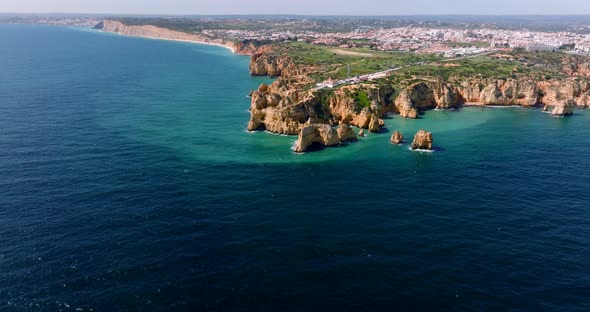 Aerial video from a partly cloudy day on the Algarve Coast, as the drone moving closer to the coast alt