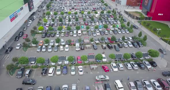 Top Aerial shopping mall parking lot fly over shot