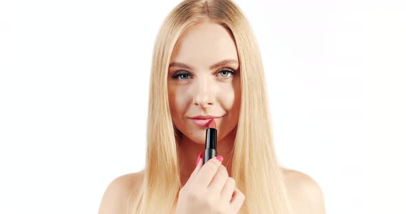 Blonde Woman Applying Lipstick