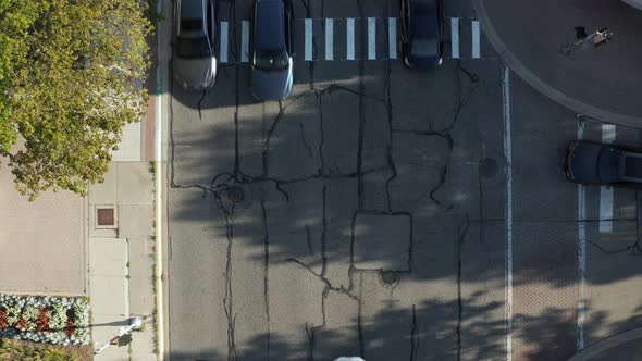 Aerial top down drone view of a pedestrian crossing on the road. cars are running on city streets. M alt