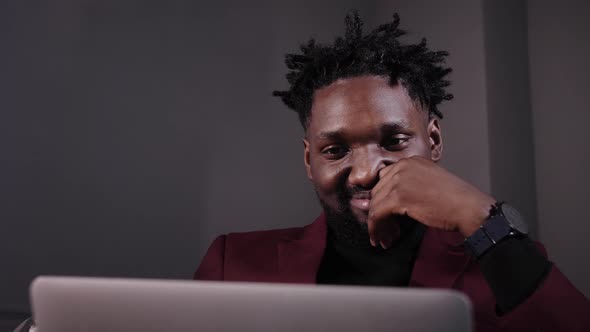 a Black Man Works at a Laptop Closeup of His Face