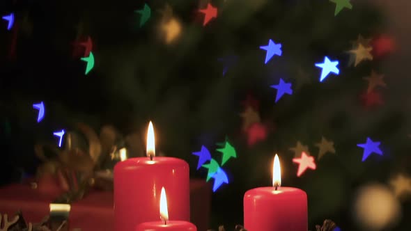 Burning Candles, Pinecones and Christmas Star Lights Creating Festive Atmosphere alt