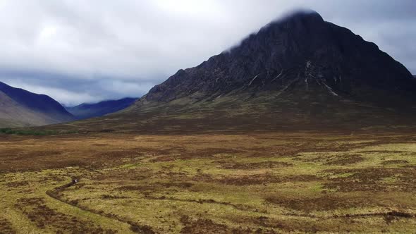 Tilt-down drone shot of scottish highland mountain valley landscape. Aerial video shot by a drone in alt