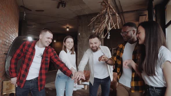 Teamwork Success Office Workers Fold Their Hands Celebrating the Launch of a New Project alt