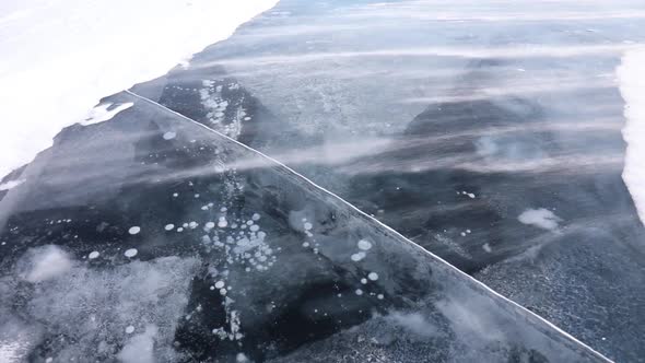 Strong Wind Drives The Snow Across The Frozen Ice Surface of Lake Baikal