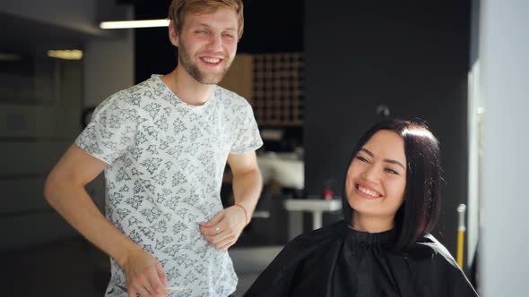 Delighted Cheerful Woman Laughing While Hairdresser Telling a Funny Story To Her alt