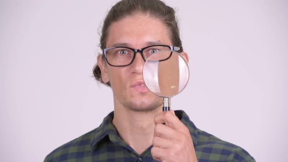 Face of Handsome Hipster Man Playing with Magnifying Glass alt