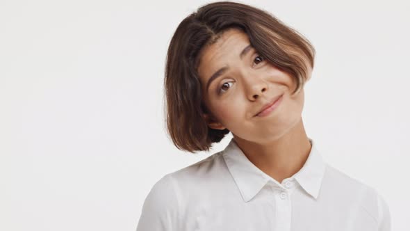 Young Beautiful Brunette East Asian Female in Shirt Looking Childish Shy Coy on White Background alt