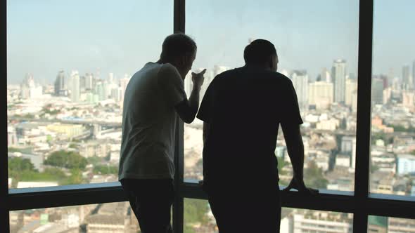 Businessmen Talking in Front of Panoramic Window