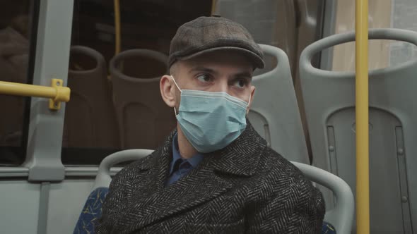 Young Man Wearing Face Mask Travelling in the Bus alt