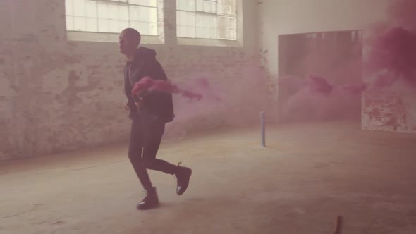 Fashionable young man in an abandoned warehouse alt