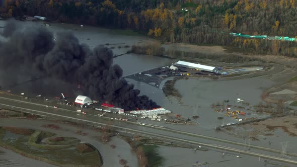 Black Smoke Rising From RV Caravan Burning In A Storage Yard After Rainstorms Caused Flooding In Abb alt