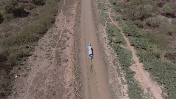 Aerial view of small boat sailing on mud canal, Tonle Sap, Cambodia. alt