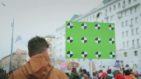 Revolution Poster in Hand. Protester on Street. Man on Street Protest. alt