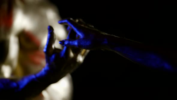 Fantasy Shot of Male and Female Body Covered Shiny Dye Stroking Hands alt