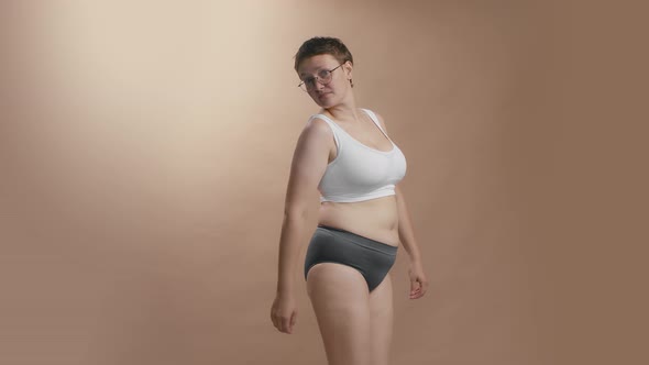 Upset Plus Size Woman Watching Herself Squeezing Her Abdomen Fat