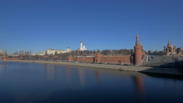 Calm Moscow River and Active Car Traffic on Embankment Along Kremlin Panoramic Shot