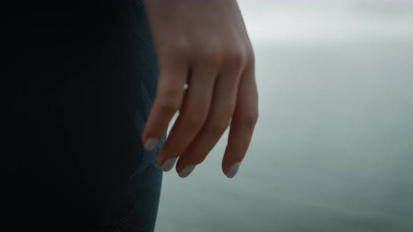 Closeup Hand Girl Standing on Hilltop Sea Beach alt