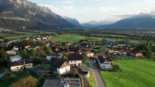 Aerial View of Liechtenstein with Houses on Green Fields in Alps Mountain Valley alt