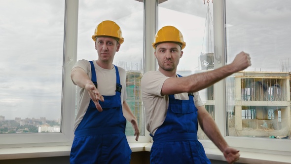 Construction Workers dancing in helmets. alt