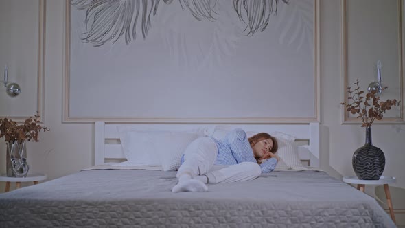 Blonde Woman Lying on Bed Awake