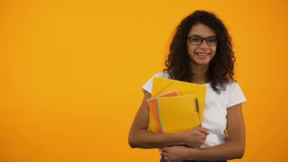 Afro-American Girl Standing With Books, International Student Exchange Programs alt