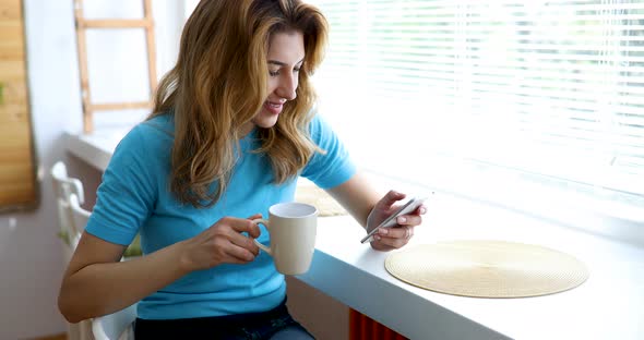 Beautiful Woman Enjoying Coffee in the Morning at Home