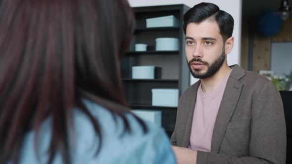 Middle Eastern Man Talking To Female Colleague Discussing Business in Office alt