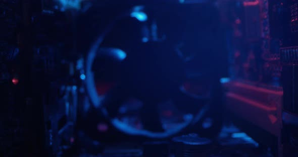 Inside A Computer A Macro Shot Of Chips And Transistors When Camera Dollying In Onto A Cooling Fan alt