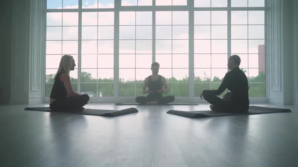 Wellness Joint Yoga Classes a Man Teaches Yoga to Two Adult Women People of Different Ages Doing alt