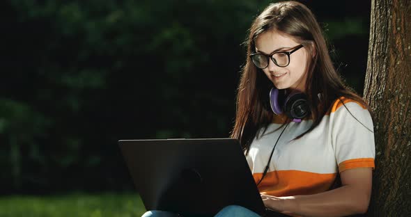 Woman Working on Laptop in Park