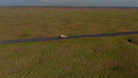 Drone View Sliding Car Travelling Peacefully on Ring Road in Iceland alt