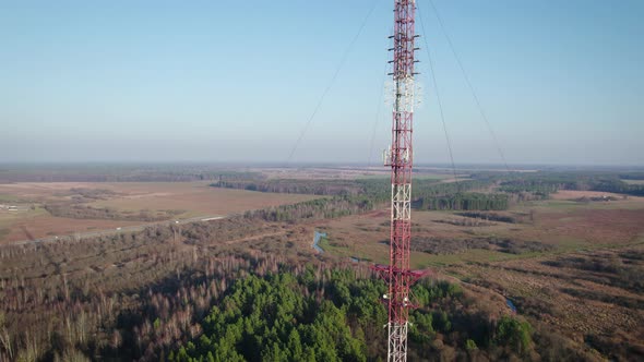 Telecommunications Tower on the Background of the Blue Sky in the Countryside alt