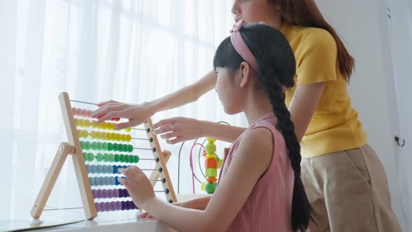 Asian beautiful young woman teacher teaching a lesson to kid at school. alt