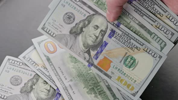 Caucasian Hand Counting Small Stack of Hundred Us Dollar Banknotes